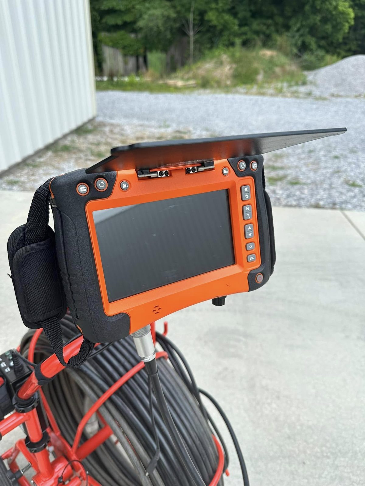 Sewer inspection camera monitor mounted on a cable reel